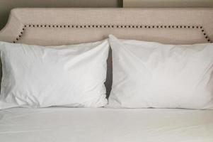 Two white pillows on luxurious bed prepared for guest in luxurious resort or hotel room photo
