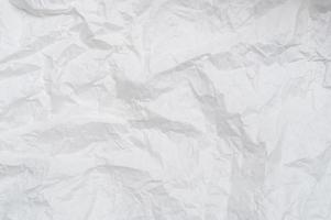 Wrinkled or crumpled white stencil paper or tissue after use in toilet or restroom with large copy space used for background texture in decorative art work photo