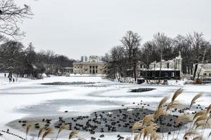 historic palace on the water in  in Warsaw, Poland during snowy winter photo