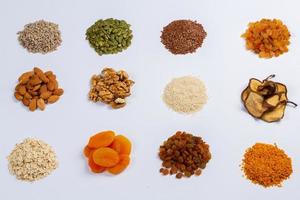 Healthy vegetarian food concept. Assortment of dried fruits, nuts and seeds on white background. Top view. photo