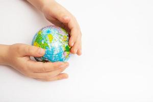 Environment for future, save the planet concept. World globe in child hands top view with copy space photo