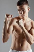 boxer pumped up muscle fist gray background workout cropped view photo