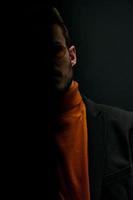 silhouette of a man in a sweater and jacket on a black background falling shadow photo