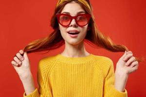 woman holding hair in red glasses fashion studio retro style photo