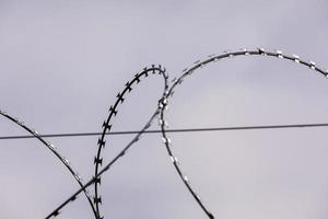 Barbed wire on the sky background. metal wire. selective focus photo