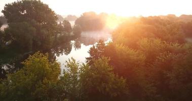 Aerial view of the meadow and river covered with fog at dawn. Ukraine video