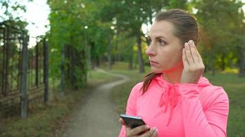 Close up of woman running through an autumn park at sunset video