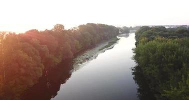 Aerial view of the meadow and river covered with fog at dawn. Ukraine video