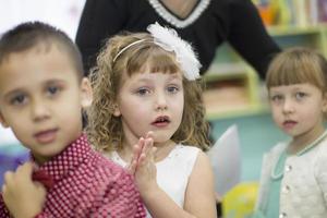 Little girl claps at a matinee. photo