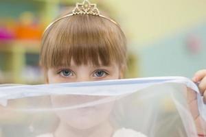 Belarus, the city of Gomil, December 27, 2018. Morning party in kindergarten.The face of the child in the crown. The eyes of a beautiful girl. photo