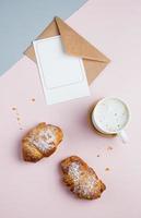 Flat lay with cup of coffee, croissants and clean empty note for text, top vie photo