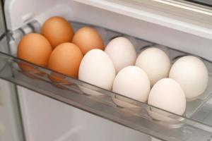 Organic chicken and white duck eggs in the fridge fresh from the farm ready for breakfast. photo