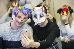 People try on carnival masks. photo