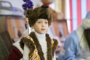 .Child in a fancy dress. Boy in a mask of a bear. photo