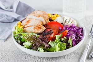 Balanced lunch in bowl. Healthy food concept. Light concrete background. photo