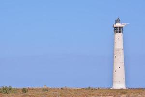 Lighthouse by the sea photo