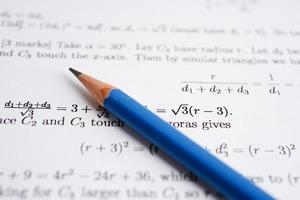 Pencil on mathematic formula exercise test paper in education school. photo