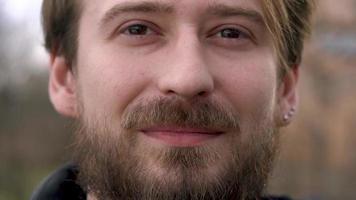 Young bearded man looking at the camera and smiling video