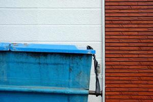 Old Blue Metal Garbage Trash Container. photo