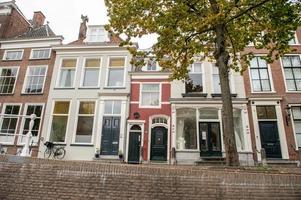 The Netherlands, Delft, October 2022. The smallest house in Delft with two doors. red house photo