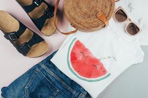 Summer women's clothing, accessories. T-shirt, denim shorts, organic rattan bag, sunglasses. photo