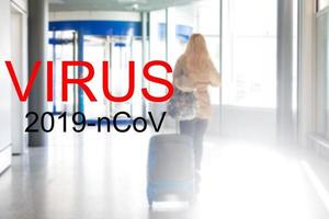 woman travel, coronavirus in China. Lady walking in public space bus station or airport. photo