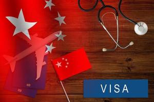 Visa to China concept. Chinese flag near passport on dark wooden background top-down copy space photo