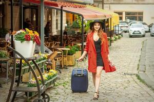 Woman is walking with suitcase photo