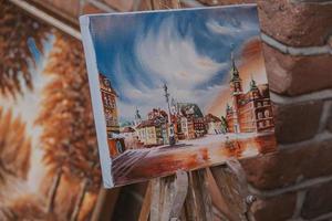 paintings on canvas showing the old town of warsaw in poland souvenirs from holidays photo