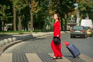 Woman crosses road through crosswalk photo