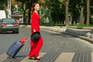 Woman crosses road through crosswalk photo