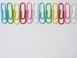 Cute and colorfull paperclips isolated on white background. Stationery photo ilustration.