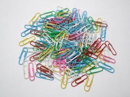 Cute and colorfull paperclips isolated on white background. Stationery photo ilustration.