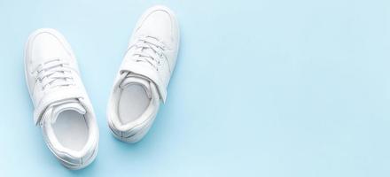 White sneakers on a blue background. photo