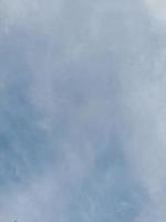 Beautiful white clouds on deep blue sky background. Large bright soft fluffy clouds are cover the entire blue sky. photo