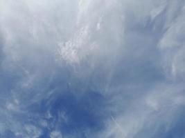 Beautiful white clouds on deep blue sky background. Large bright soft fluffy clouds are cover the entire blue sky. photo