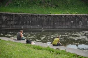 03.07.2022 Leningrad region. children in the summer sit on the shore with fishing rods photo