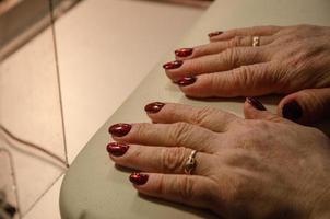 hands with bardic nail polish, manicure services photo