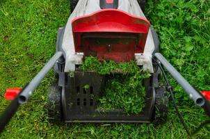 lawn mower mows grass on the lawn photo