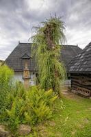 historic wooden rural buildings with an open-air museum in Dobczyce Polish mountains on a summer day photo