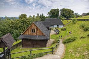 historic wooden rural buildings with an open-air museum in Dobczyce Polish mountains on a summer day photo