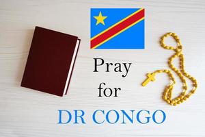 Pray for Democratic Republic Congo. Rosary and Holy Bible background. photo