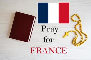 Pray for France. Rosary and Holy Bible background. photo