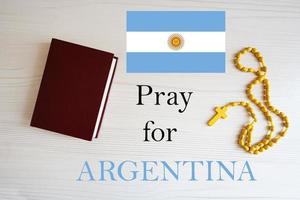 Pray for Argentina. Rosary and Holy Bible background. photo