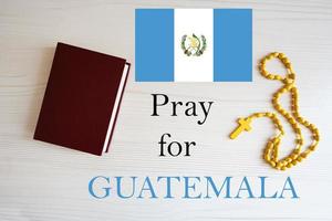 Pray for Guatemala. Rosary and Holy Bible background. photo