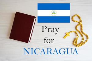 Pray for Nicaragua. Rosary and Holy Bible background. photo