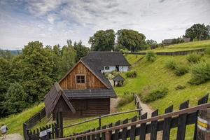 historic wooden rural buildings with an open-air museum in Dobczyce Polish mountains on a summer day photo