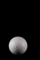 Golf ball on black background photo