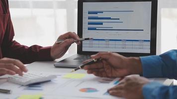 Financial analysts analyze business financial reports on a digital tablet planning investment project during a discussion at a meeting of corporate showing the results of their successful teamwork. video
