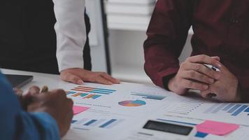 Financial analysts analyze business financial reports on a digital tablet planning investment project during a discussion at a meeting of corporate showing the results of their successful teamwork. video
